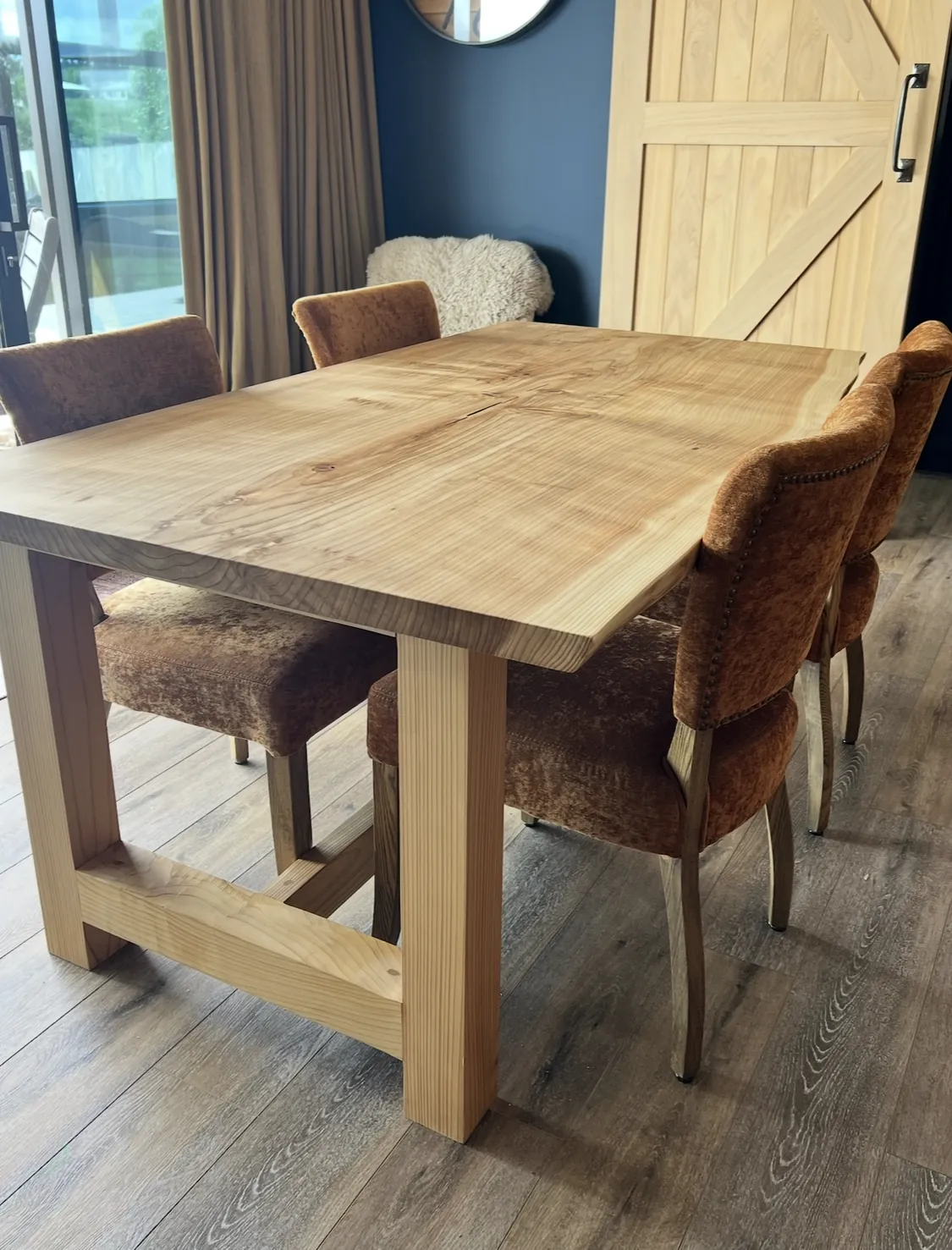 Handmade timber dining table with barn door and navy wall